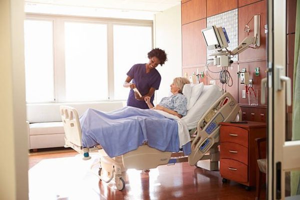 stock-photo-hospital-nurse-with-digital-tablet-talks-to-senior-patient-361341644